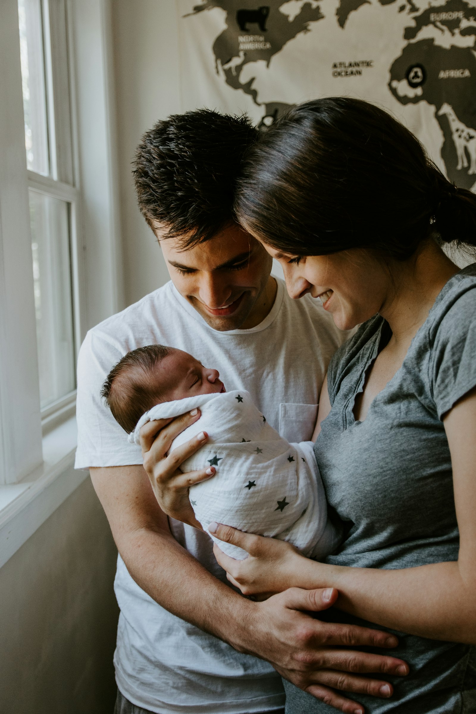 Parents holding their newborn child representing AZK life insurance coverage