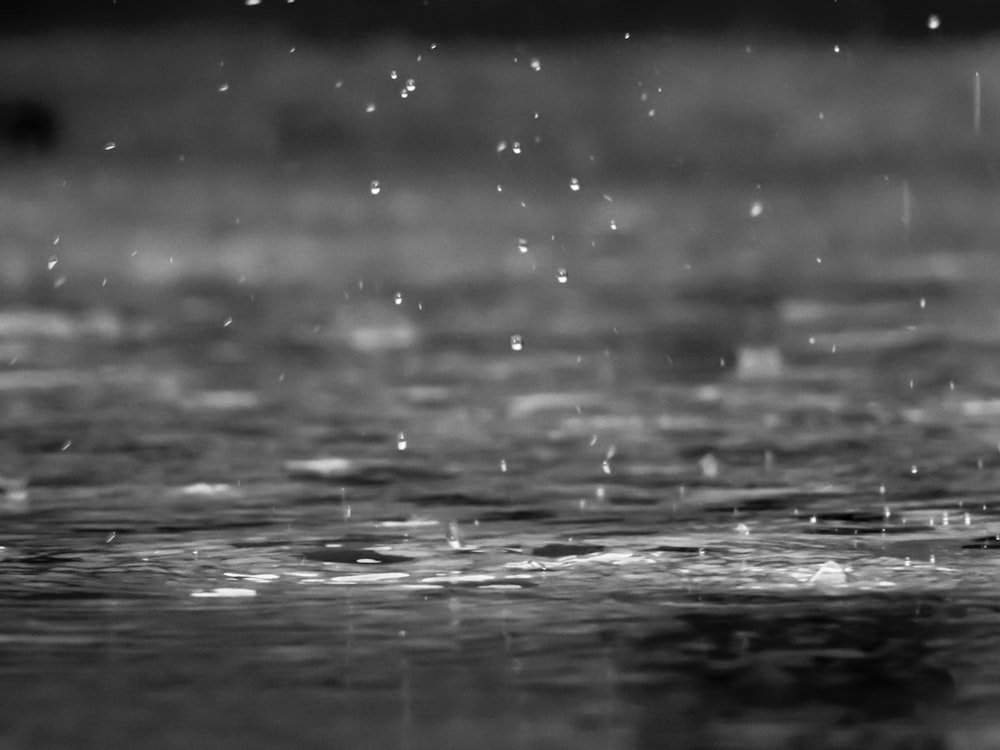 Rain falling on water representing AZK umbrella insurance coverage